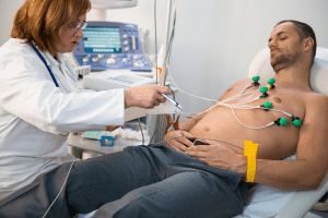 Electrocardiogram exam with machine and patient
