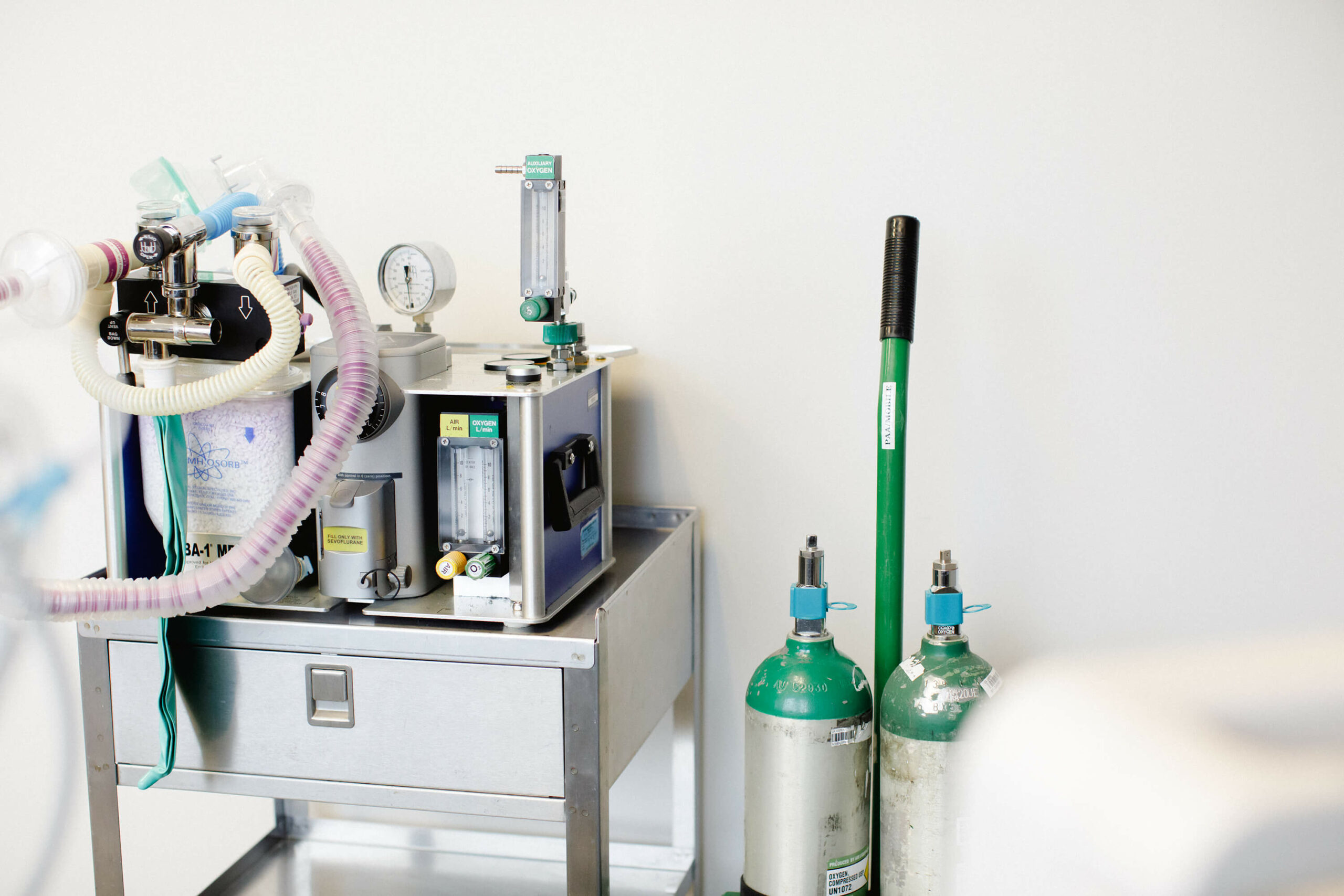 Infinium OBA-1 portable anesthesia machine on rolling cart with oxygen cylinders