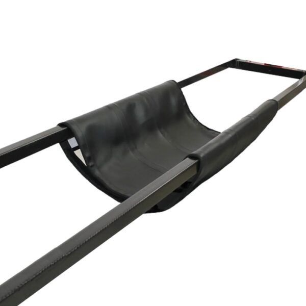 Black leg sling hanging between the frame rails of a Jackson Spine Table